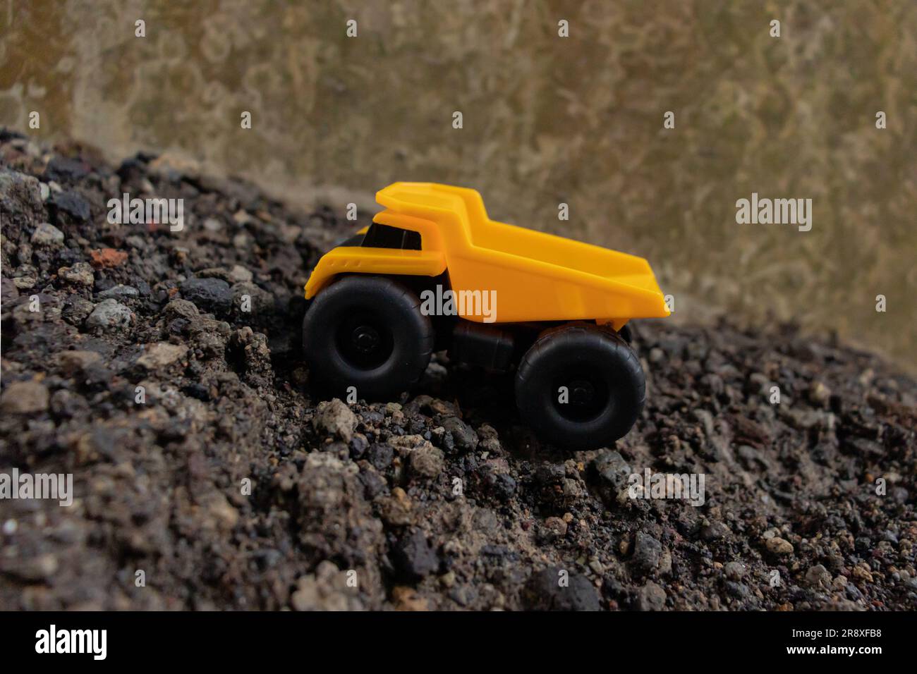 A dump truck on a pile of stones and sand, after some edits. Stock Photo