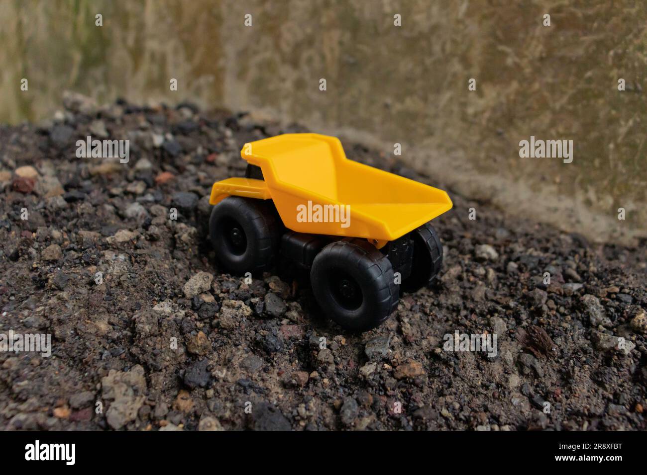 A dump truck on a pile of stones and sand, after some edits. Stock Photo