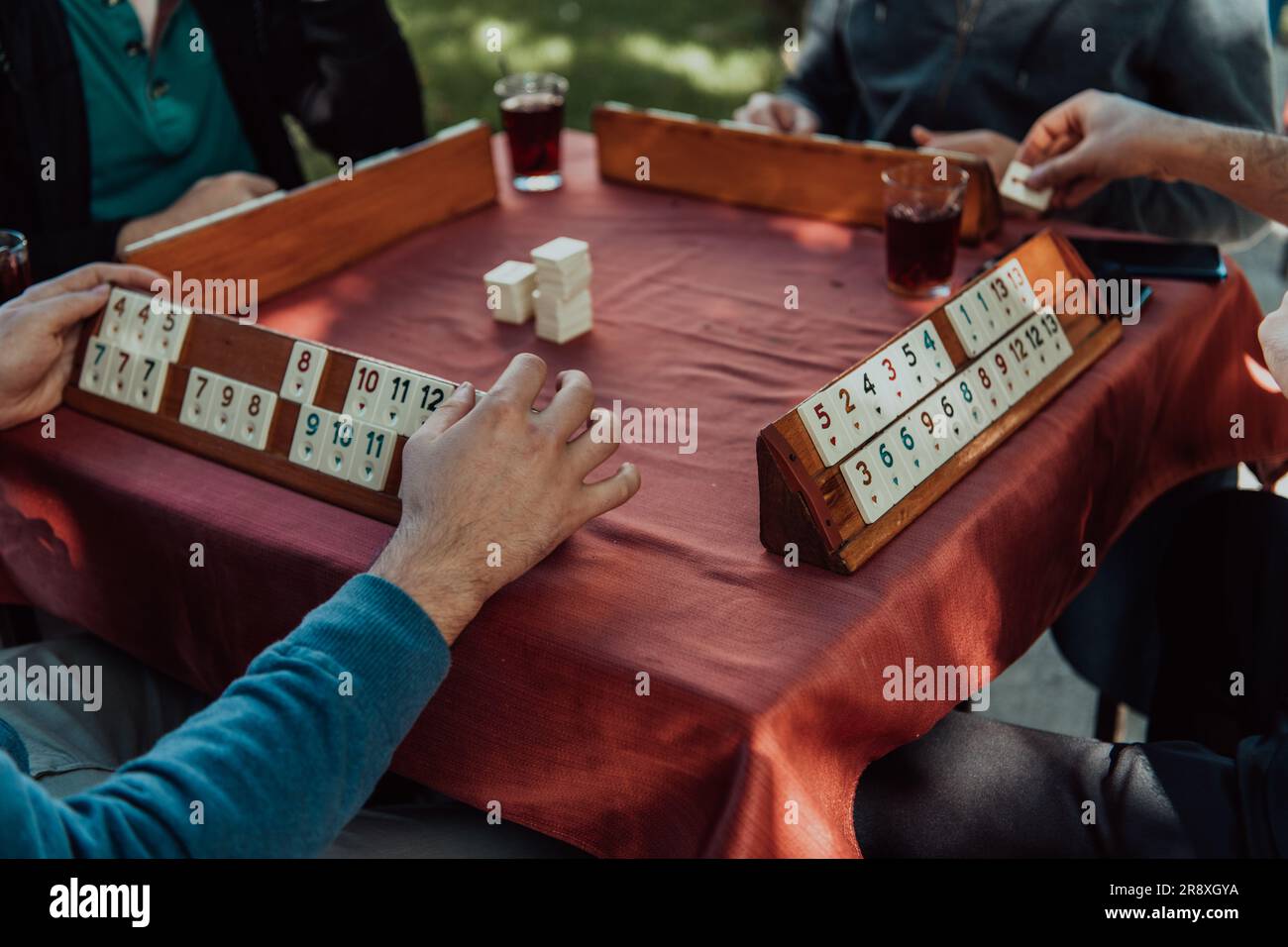 A group of men drink traditional Turkish tea and play a Turkish game ...