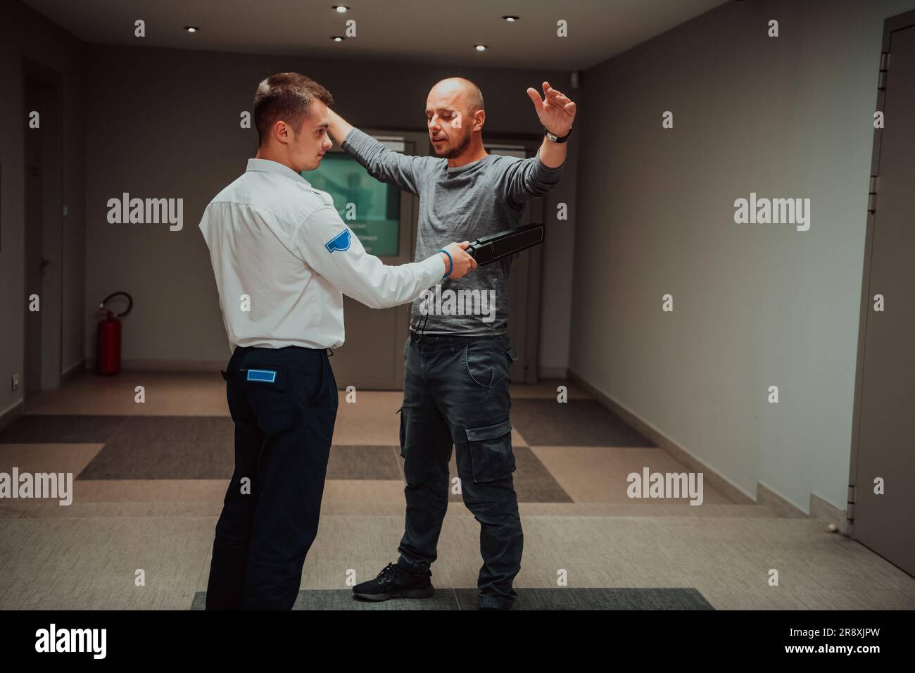 Security guard making body searching procedure on man for finding