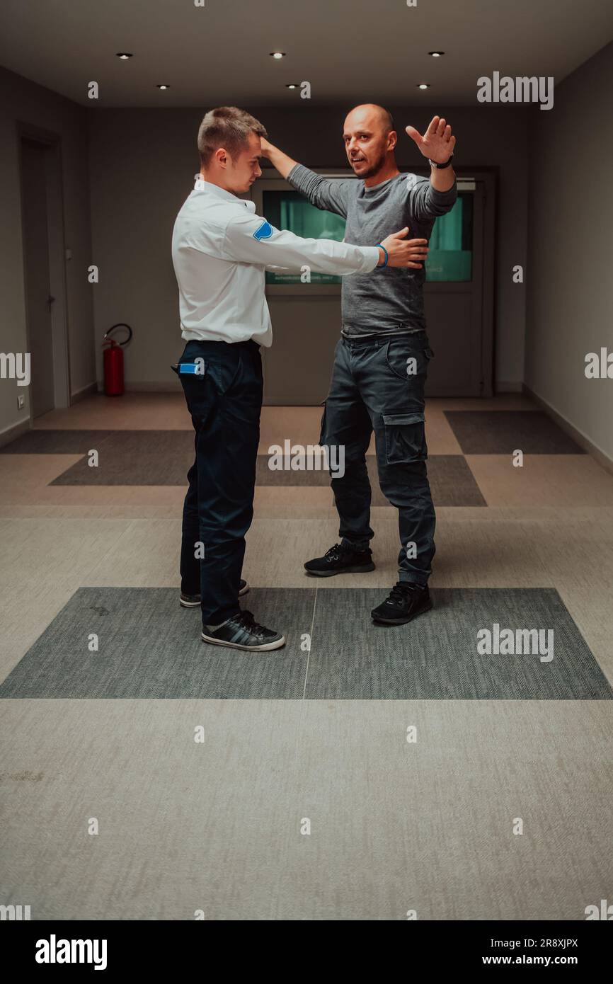 Security guard making body searching procedure on man for finding