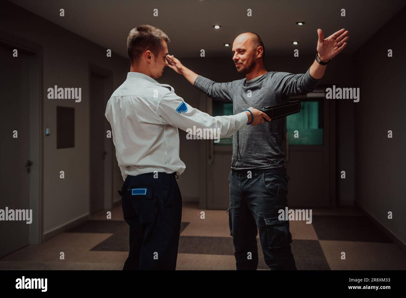 Security guard making body searching procedure on man for finding