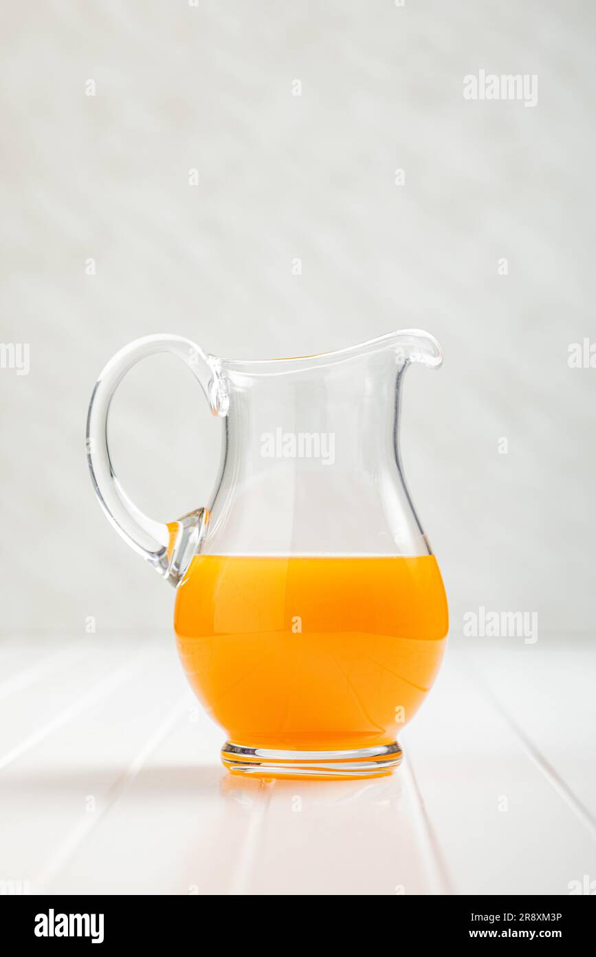 https://c8.alamy.com/comp/2R8XM3P/a-pitcher-of-fruit-juice-orange-juice-on-the-white-table-2R8XM3P.jpg