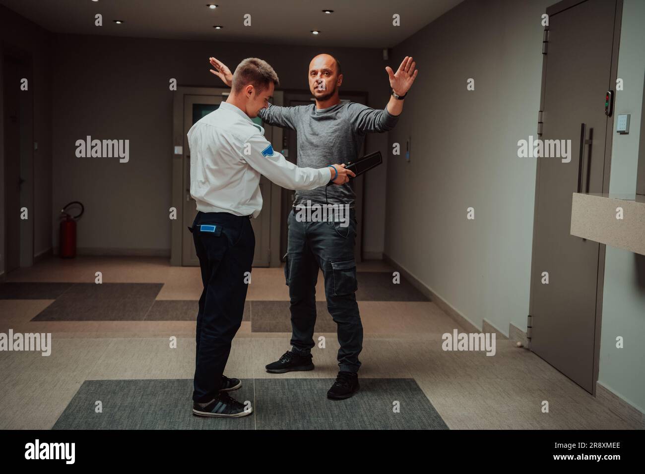 Security guard making body searching procedure on man for finding