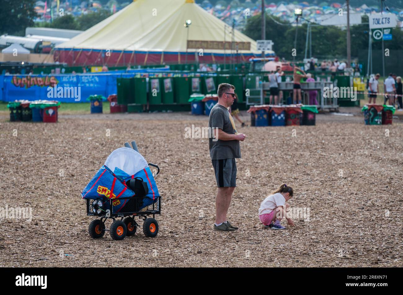 Glastonbury, UK. 23rd June, 2023. A young child plays with the wood