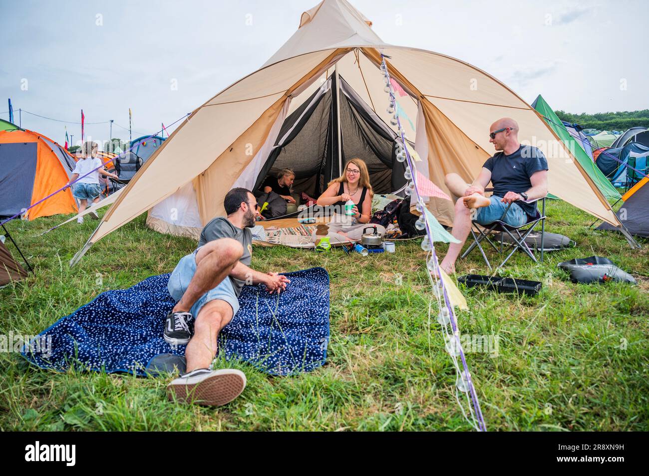 Glastonbury, UK. 23rd June, 2023. Two couples share a large bell tent