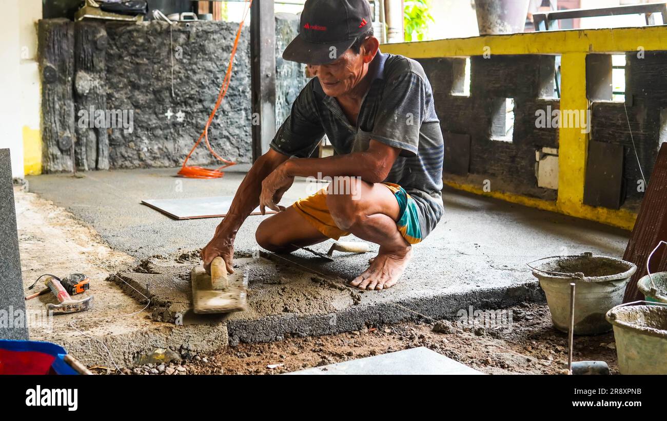Jakarta, Indonesia 23 June 2023 A male construction worker installs a
