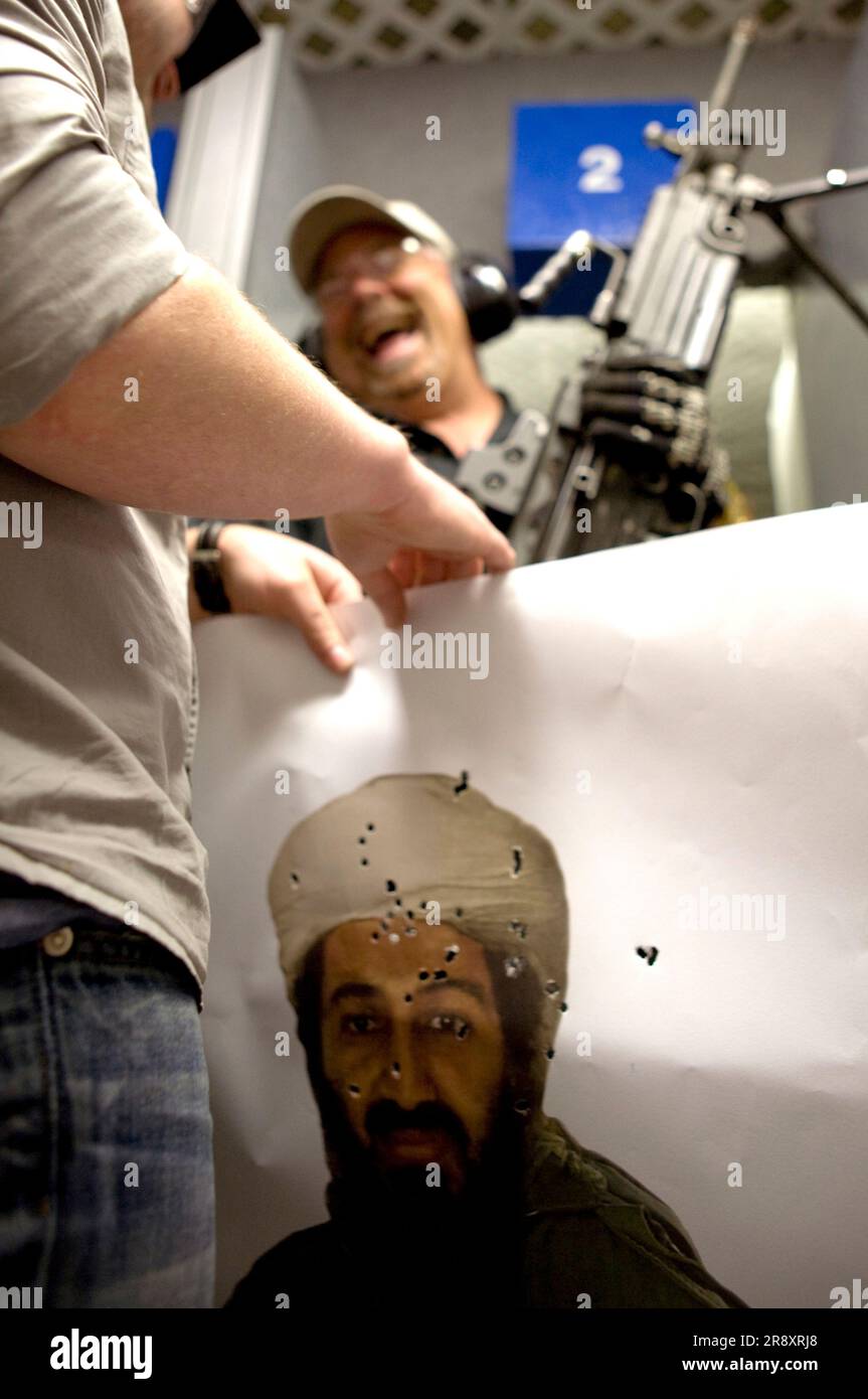 A tourist rolls his Osama Bin Laden target after shooting in an indoor range in Las Vegas, Nevada. Stock Photo