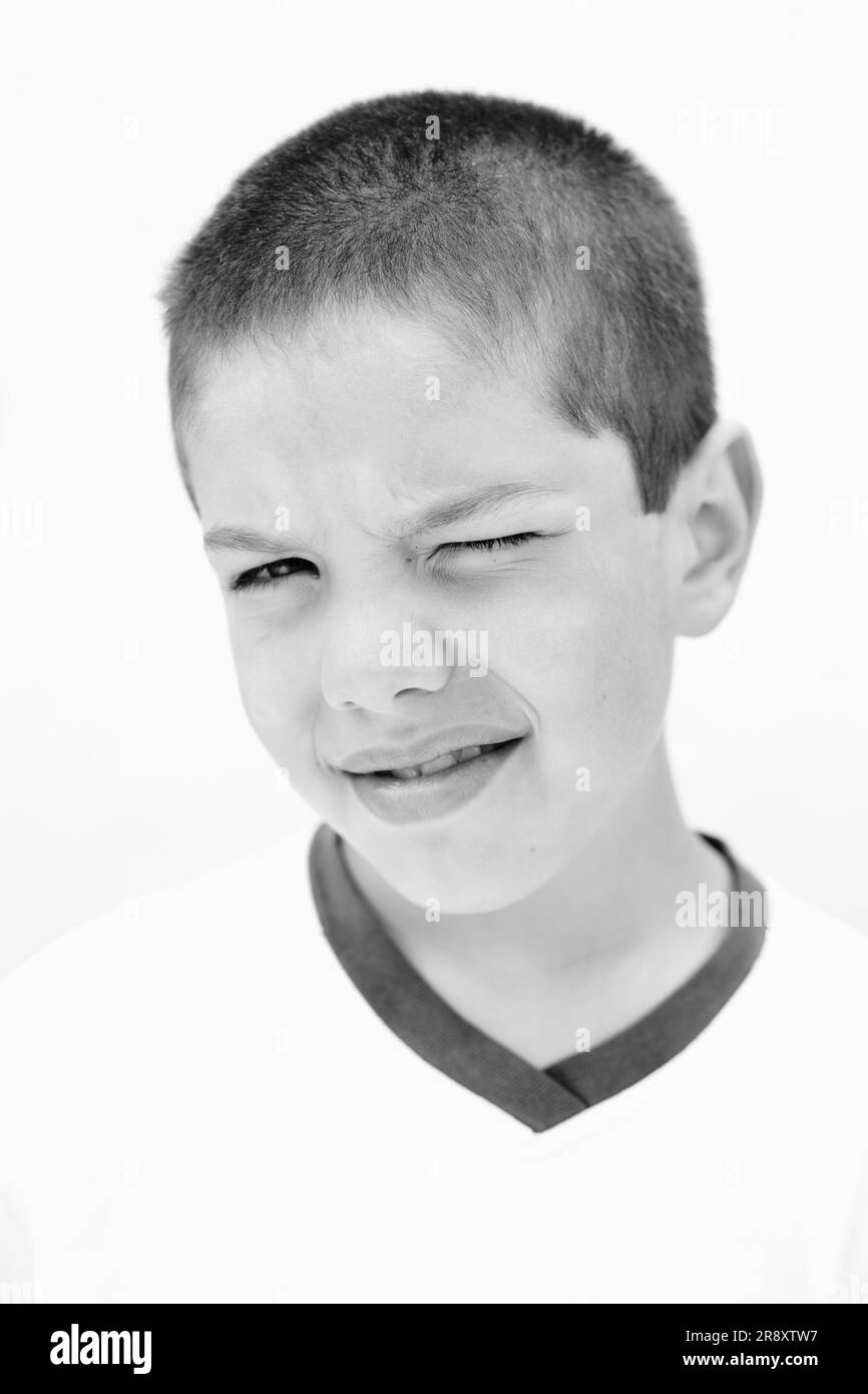 Portrait (headshot) of a kid blinking one eye. Esquel, Chubut