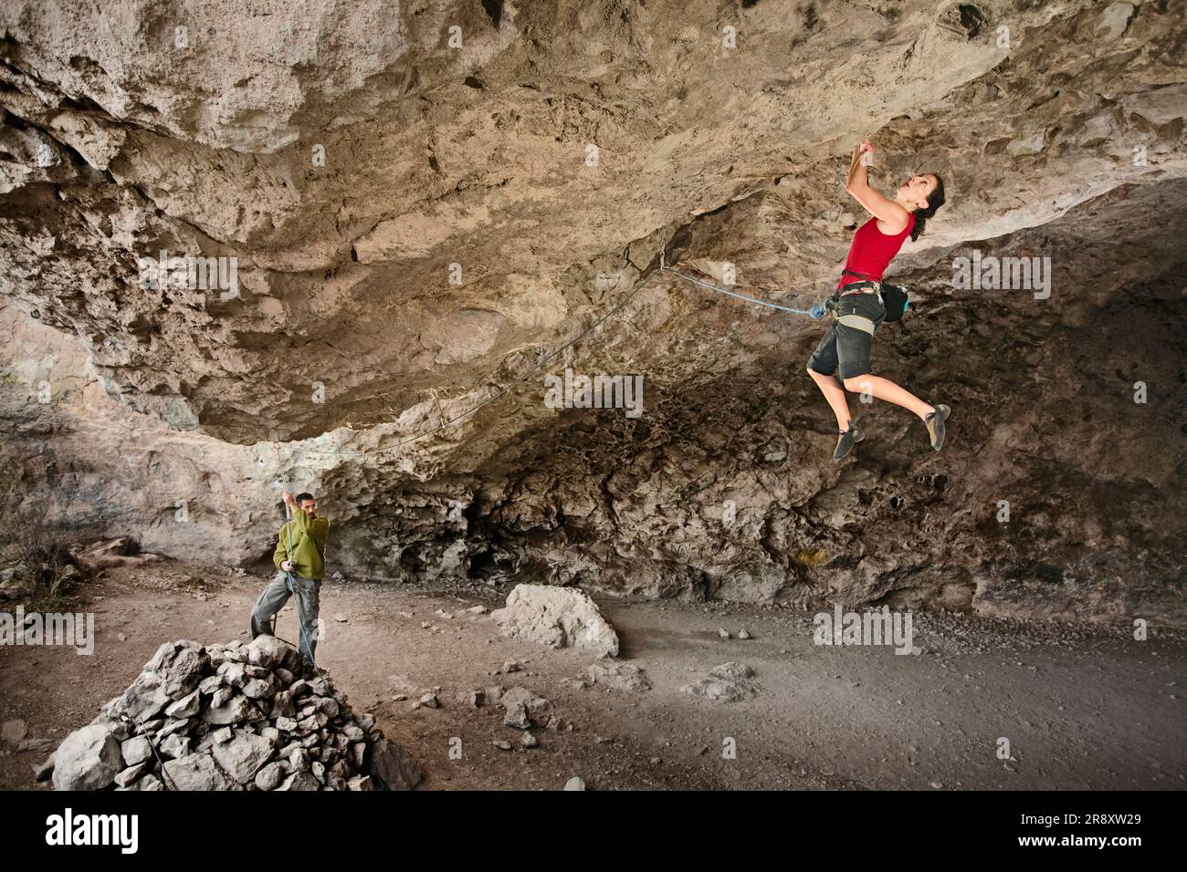Cimbing Rocks A middle aged woman rock cimbing at the Actopan Cave, Hidalgo, Mexico ...