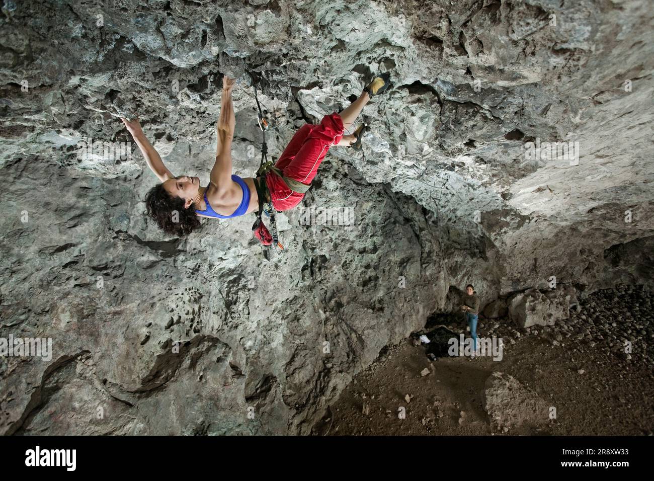 Cimbing Rocks A middle aged woman rock cimbing at the Actopan Cave, Hidalgo, Mexico ...