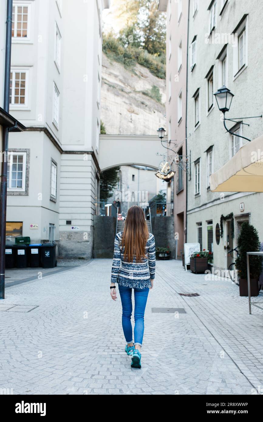 young female tourist walks the streets of Salzburg in Austria Stock Photo