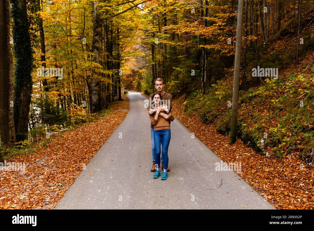 tourists man and woman walking in the alpine forest in nature Stock ...