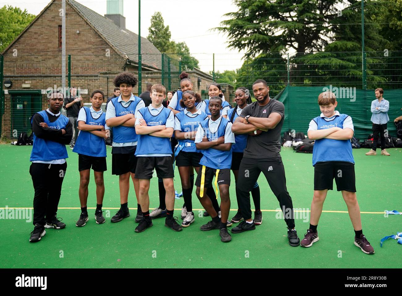 Kevin Byard from the NFL team Tennessee Titans poses for a photo with students during a visit to Gladesmore Community School, London. Stock Photo