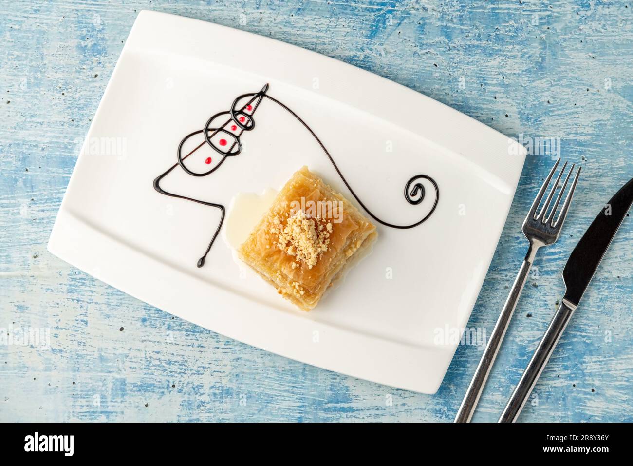 Turkish baklava with hazelnuts on a white porcelain plate Stock Photo