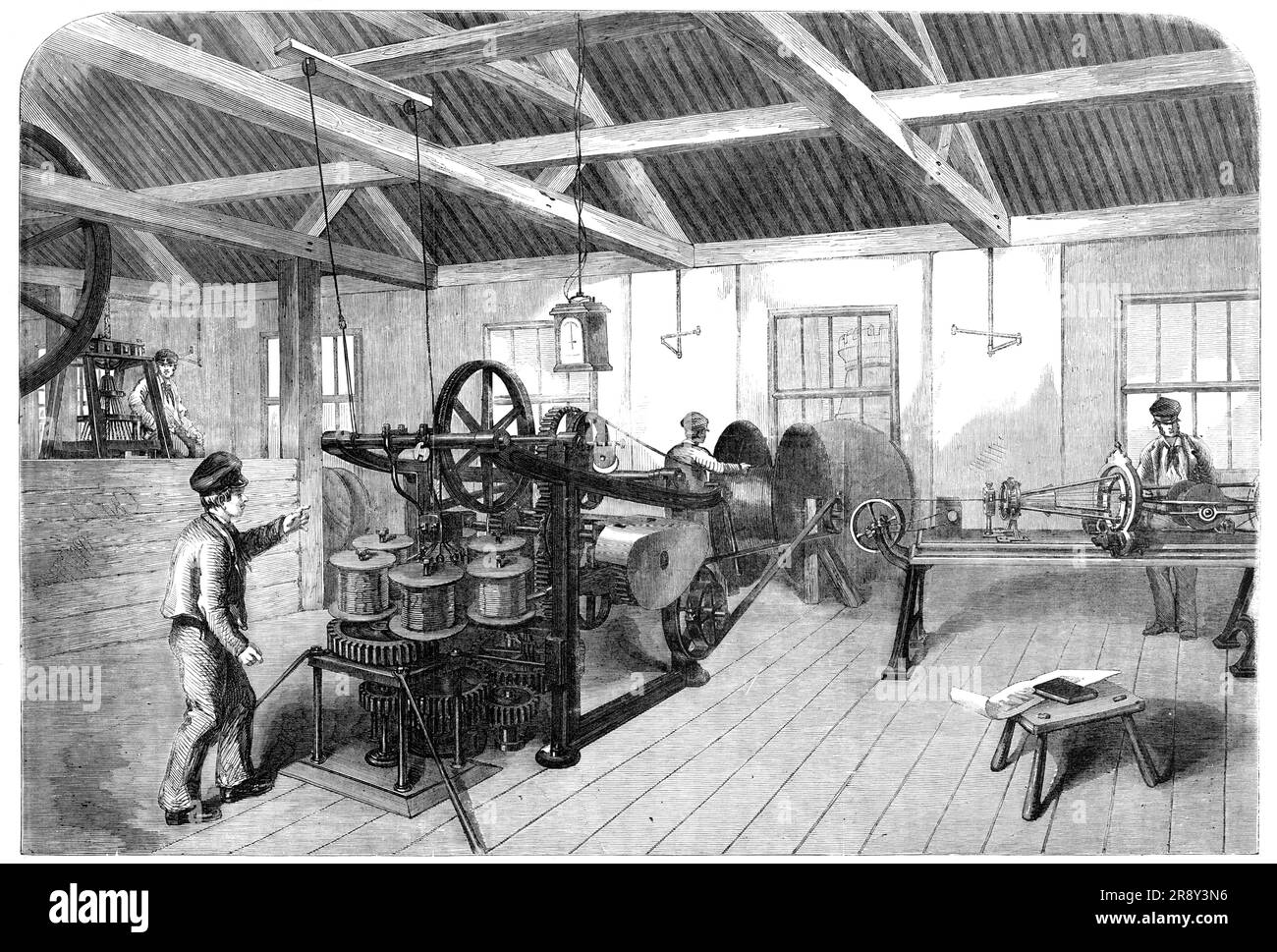 Manufacture of the Atlantic Submarine Cable, at Glass, Elliott, and Co.'s Works, East Greenwich, [London], 1857. The firm has '...undertaken to complete 1250 miles within a specified period...The Atlantic cable may be divided into two parts, the core and the armour - the former being the conductor to be actually employed in the transmission of electrical sensations under the ocean between Europe and America, the latter only a protective and strengthening assistant whereby to deposit the insulated wire at the bottom of the sea. The core is composed of seven copper wires of the gauge known as No Stock Photo