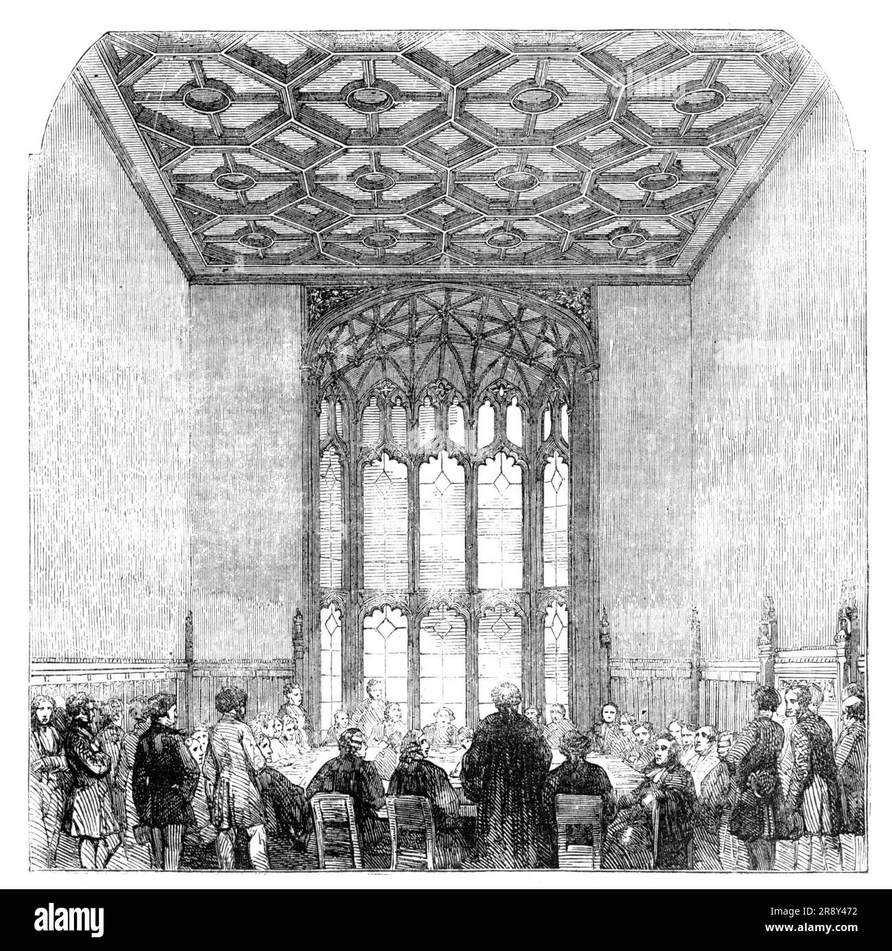 Committee-room, House of Commons, 1857. Interior of the Palace of Westminster, London. 'It would be difficult to point to any edifice, ancient or modern, in which the style and character of the architecture are more completely carried out than in the new Houses of Parliament. Every apartment and means of communication throughout the vast edifice has its characteristics of the Tudor palatial style, which Sir Charles Barry has adopted...[Depicted] is one of the south end Committee-rooms in the river front of the Palace: it has a beautiful window, and a ceiling divided into compartments by deep m Stock Photo