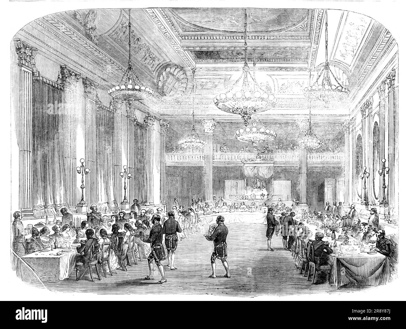 Grand Banquet to the Knights of St. Patrick, in Dublin Castle, 1857. 'A grand Chapter of the Most Illustrious Order of St. Patrick was held...in the Presence Chamber...for the investure of the Earl of Granard and Viscount Gough, as Knights of the Order...The ceremony, which commenced at three o'clock, was brief, but of an impressive character, and was in every particular conducted under the direction of Sir Bernard Burke, the Ulster King of Arms, in strict accordance with the statutes and precedents...The entire hall has been recently painted and ornamented, and the effect produced by the soft Stock Photo