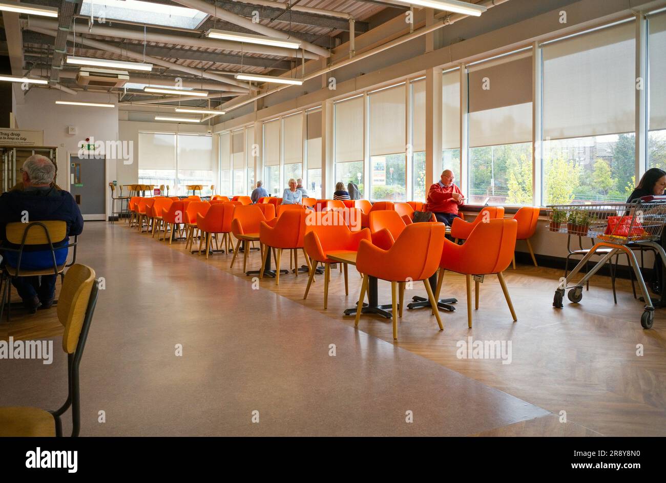 Bright orange seating at the Sainsbury's cafe in the Falsgrove area of Scarborough Stock Photo