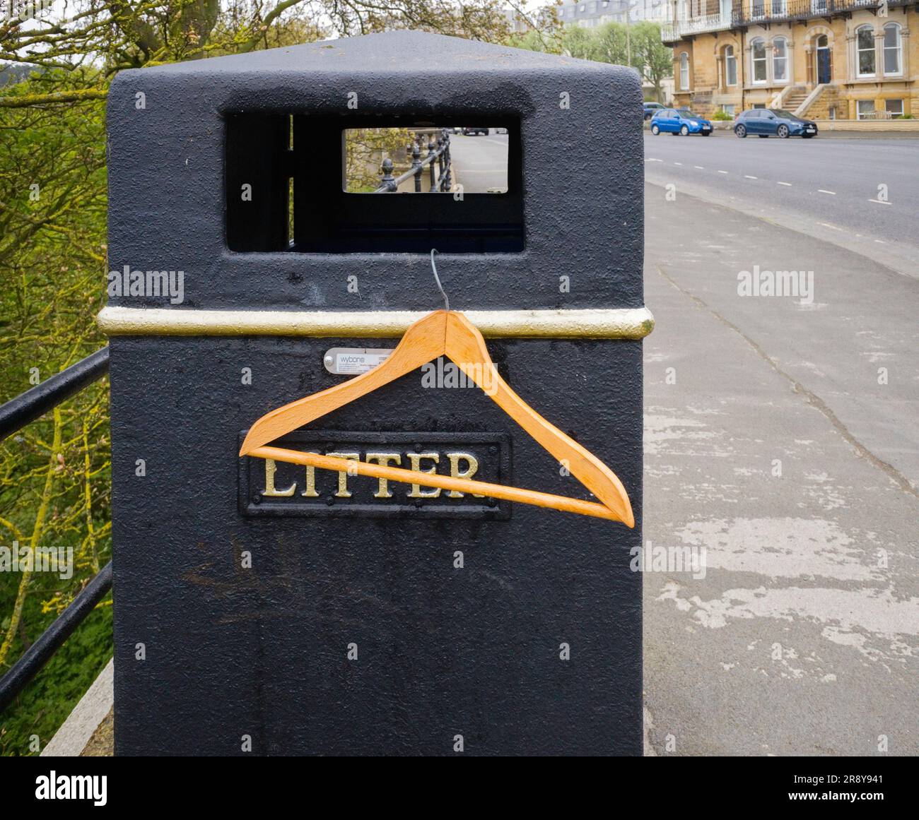 Wooden coat hanger and a litter bin Stock Photo Alamy