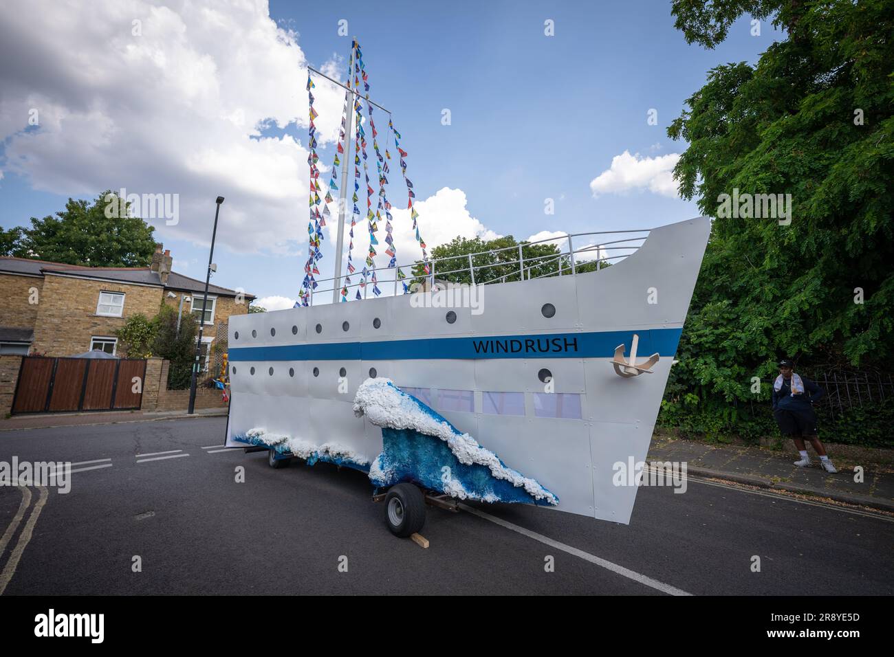 London, UK. 22nd June 2023. Windrush 75: Procession. A replica of HMT Windrush Empire ship leaves Herne Place as part of procession celebrations towards Brixton's Windrush Square. The procession is part of the celebrations of the Windrush migrant generation who would go on to shape modern Britain. Credit: Guy Corbishley/Alamy Live News Stock Photo