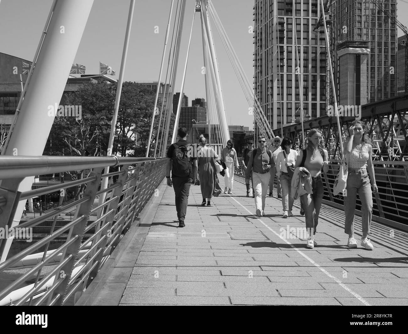LONDON, UK JUNE 08, 2023 People crossing Golden Jubilee Bridge over