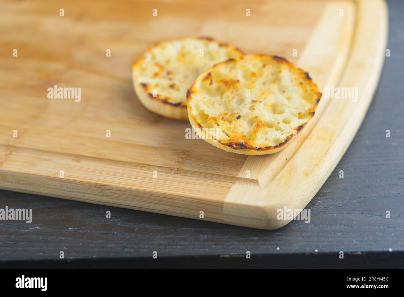 English muffin toast on cutting board copy space food backgrounds details menus banner space copy text design Stock Photo