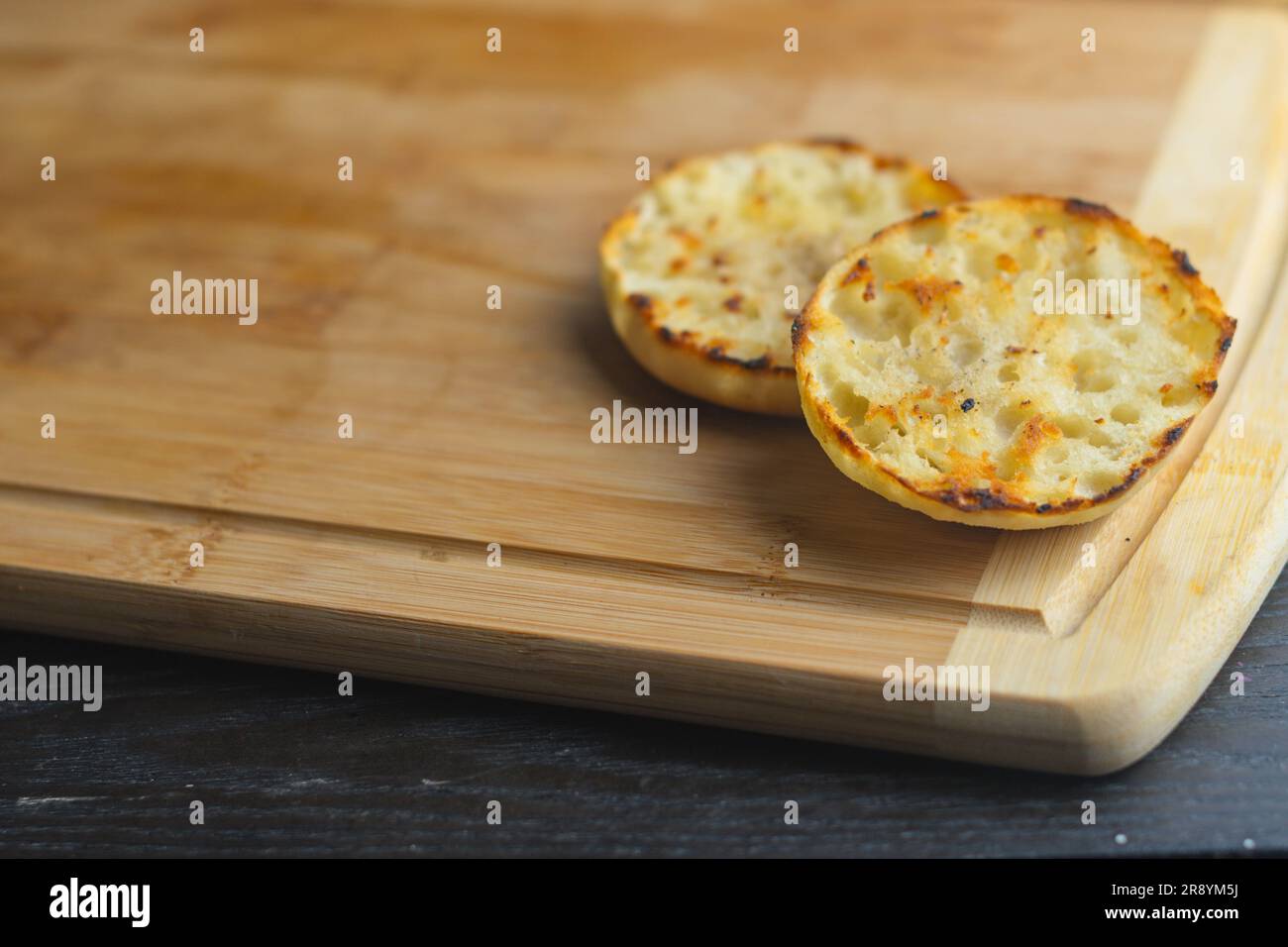 English muffin toast on cutting board copy space food backgrounds details menus banner space copy text design Stock Photo