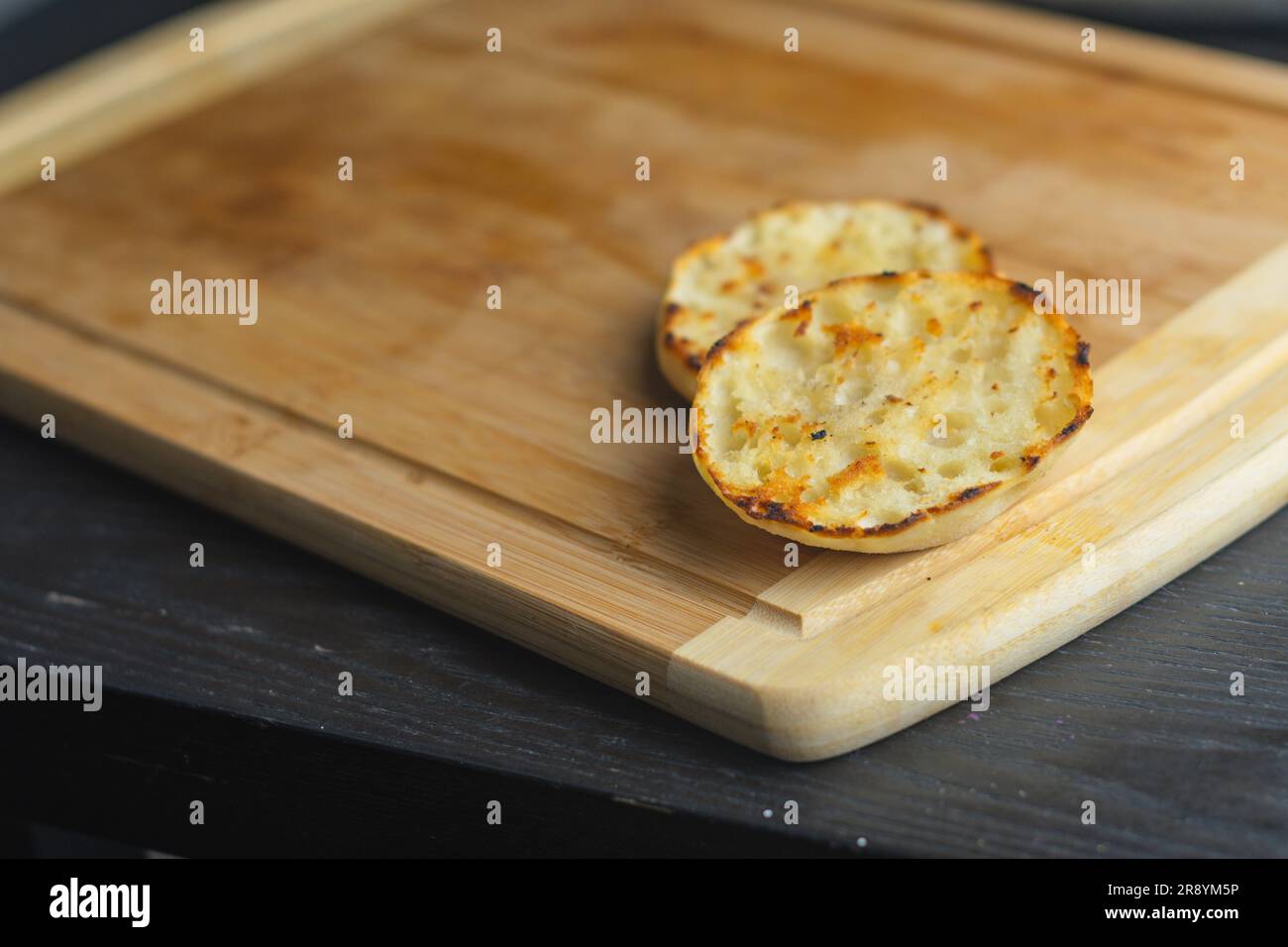 English muffin toast on cutting board copy space food backgrounds details menus banner space copy text design Stock Photo