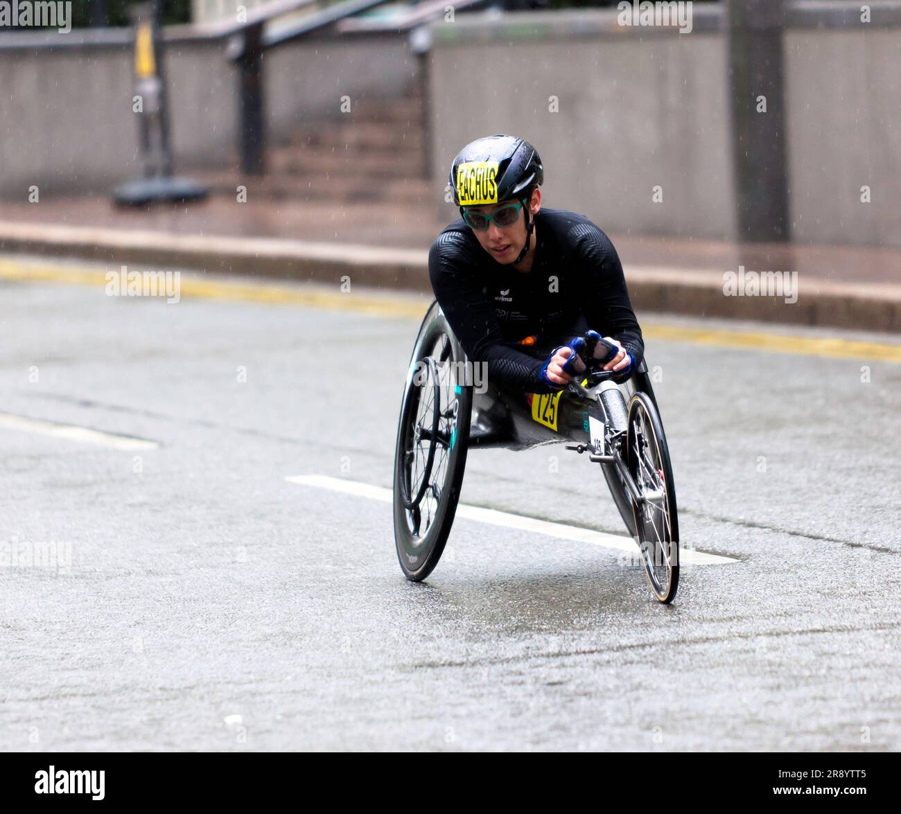 Patricia Eachus (SUI), passing through Cabot Square, on her way to finishing 16th, in the Women's Elite Wheelchair Race in the 2023 London Marathon Stock Photo