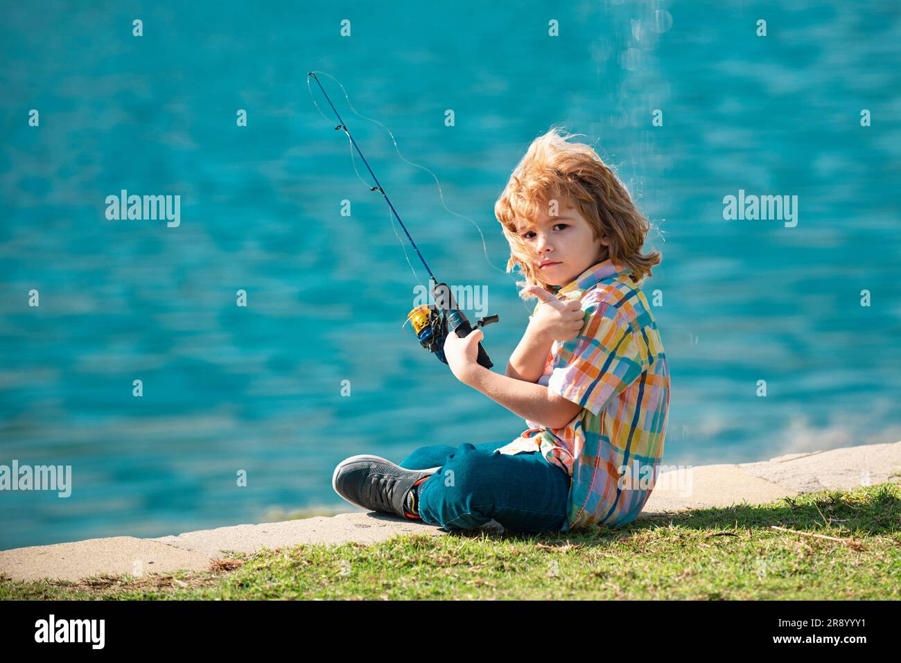 Fishing concept. Child fishing on the lake. Young fisher. Boy with