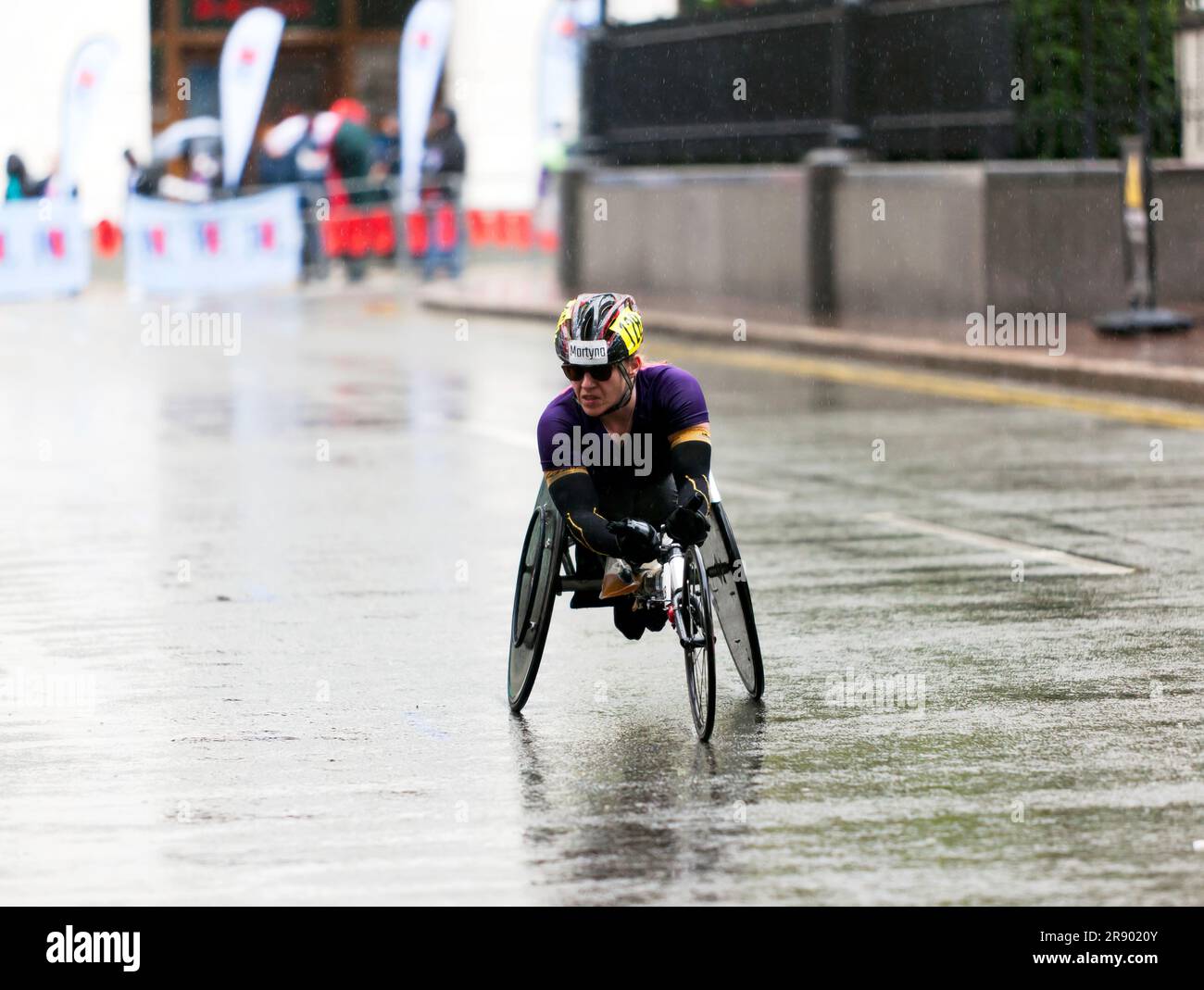 Patricia Eachus (SUI), passing through Cabot Square, on her way to finishing 16th, in the Women's Elite Wheelchair Race in the 2023 London Marathon Stock Photo