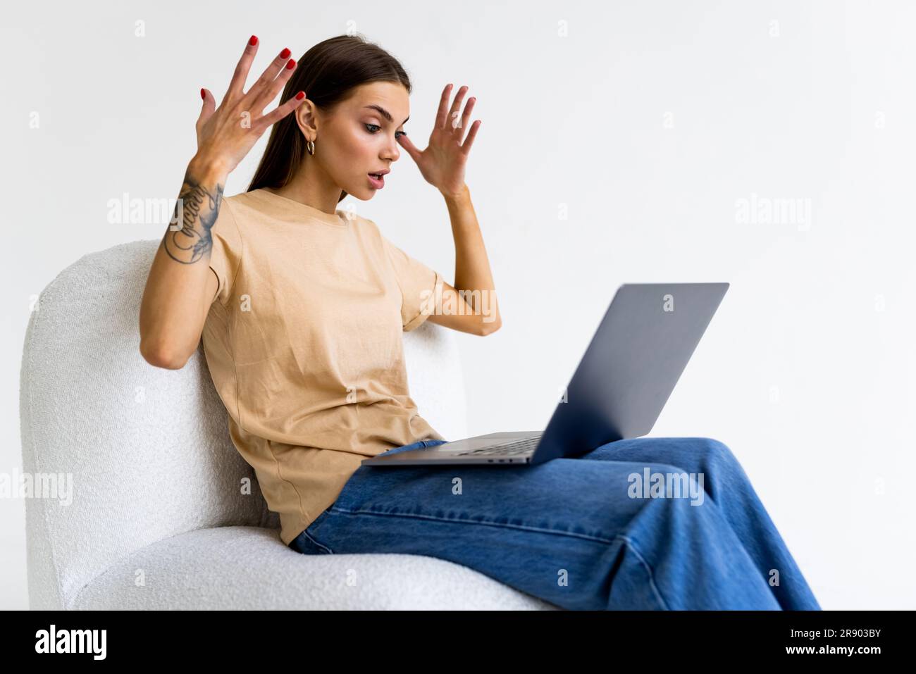 Confused woman working with a laptop, isolated over white background ...