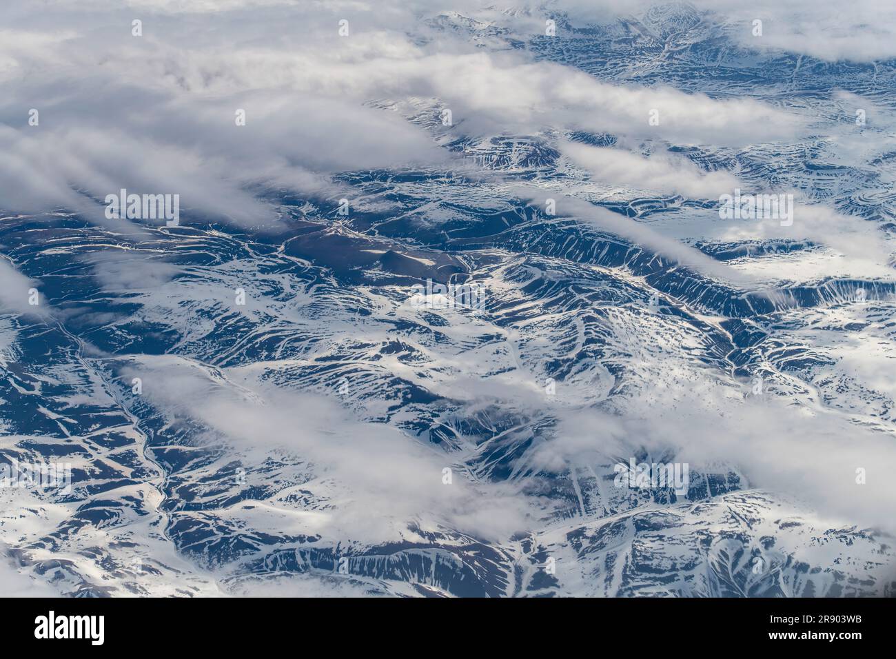 Aerial view at 38,000 feet of part of the mountains and hills on landmass of Nunavut, a territory of northern Canada, forming most of the Canadian Arc Stock Photo
