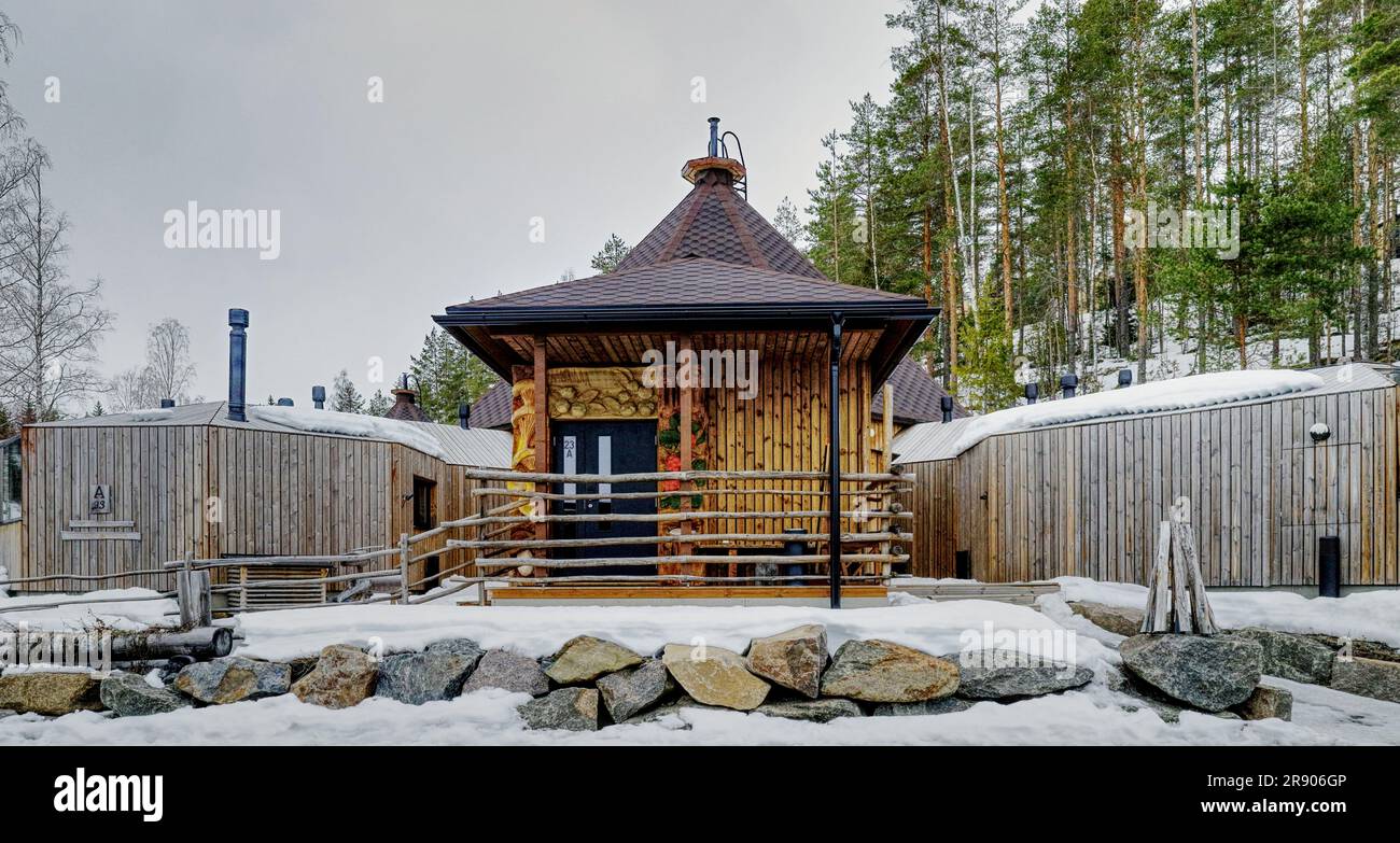 Jarvisydan Resort, Rantasalmi, Finland - Distinctive wooden lodges providing accommodation at the resort pictured in winter with snow on the ground Stock Photo