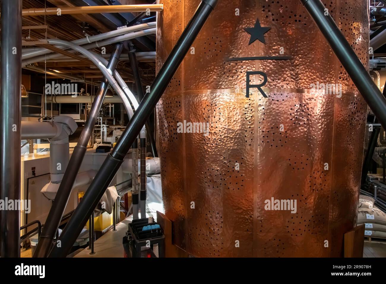 Seattle, WA, USA-July 2022; Close up view of one a large copper kettle with wholes in the shape of the world map in the flagship store Starbucks Reser Stock Photo