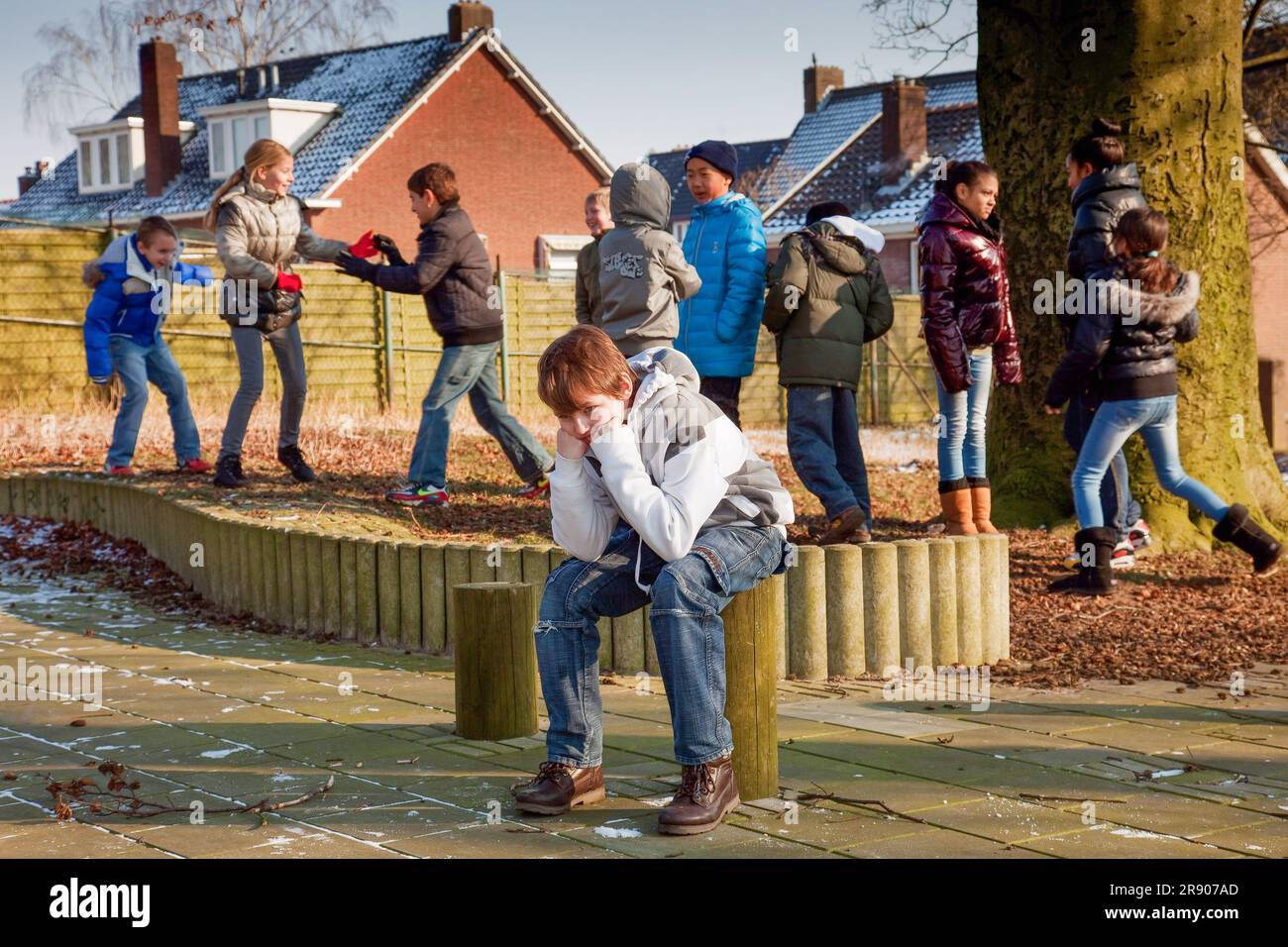 Netherlands, a child is left out and feels bullied in the playground of a primary school. Stock Photo