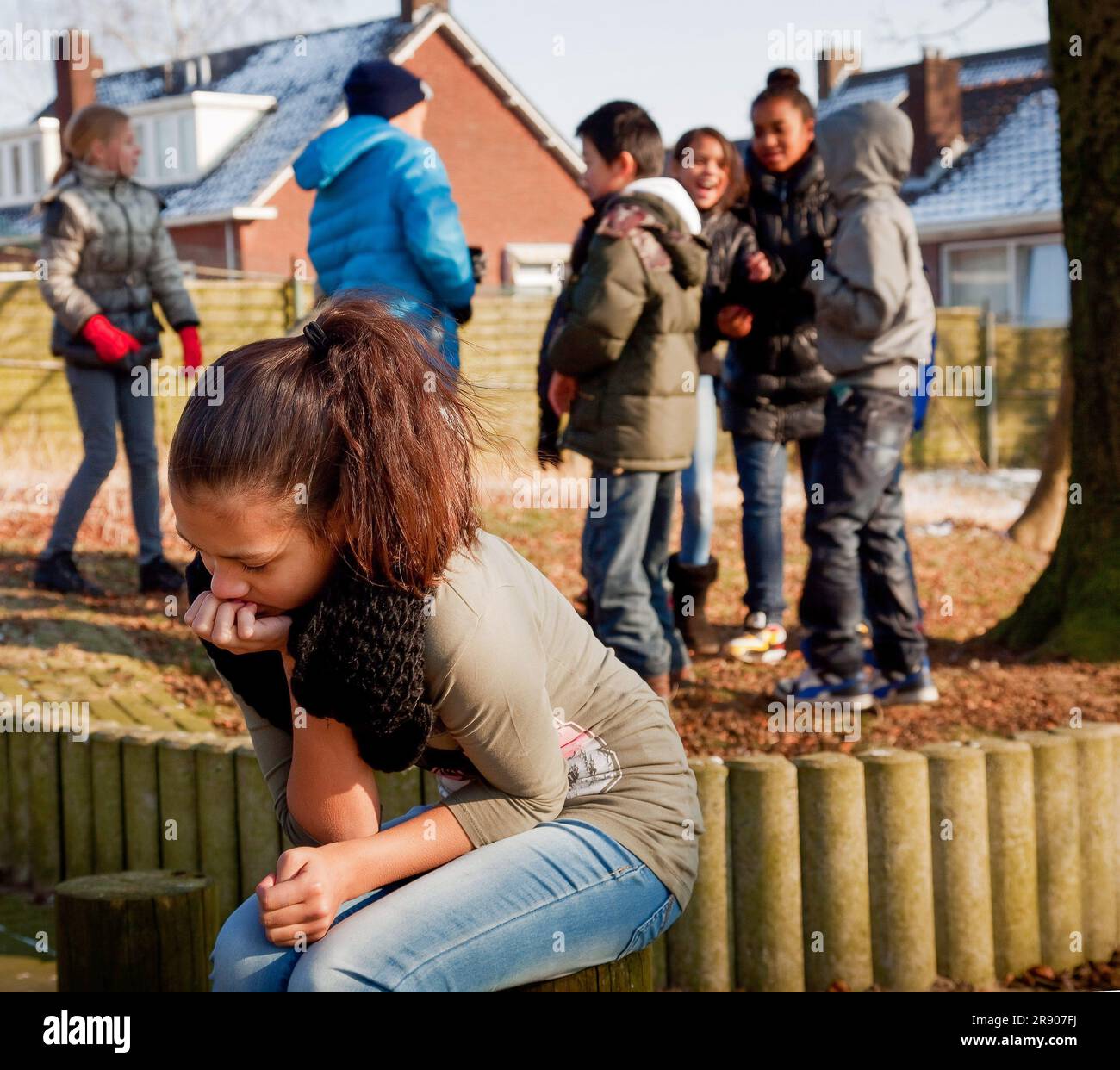 Netherlands, a child is left out and feels bullied in the playground of a primary school. Stock Photo