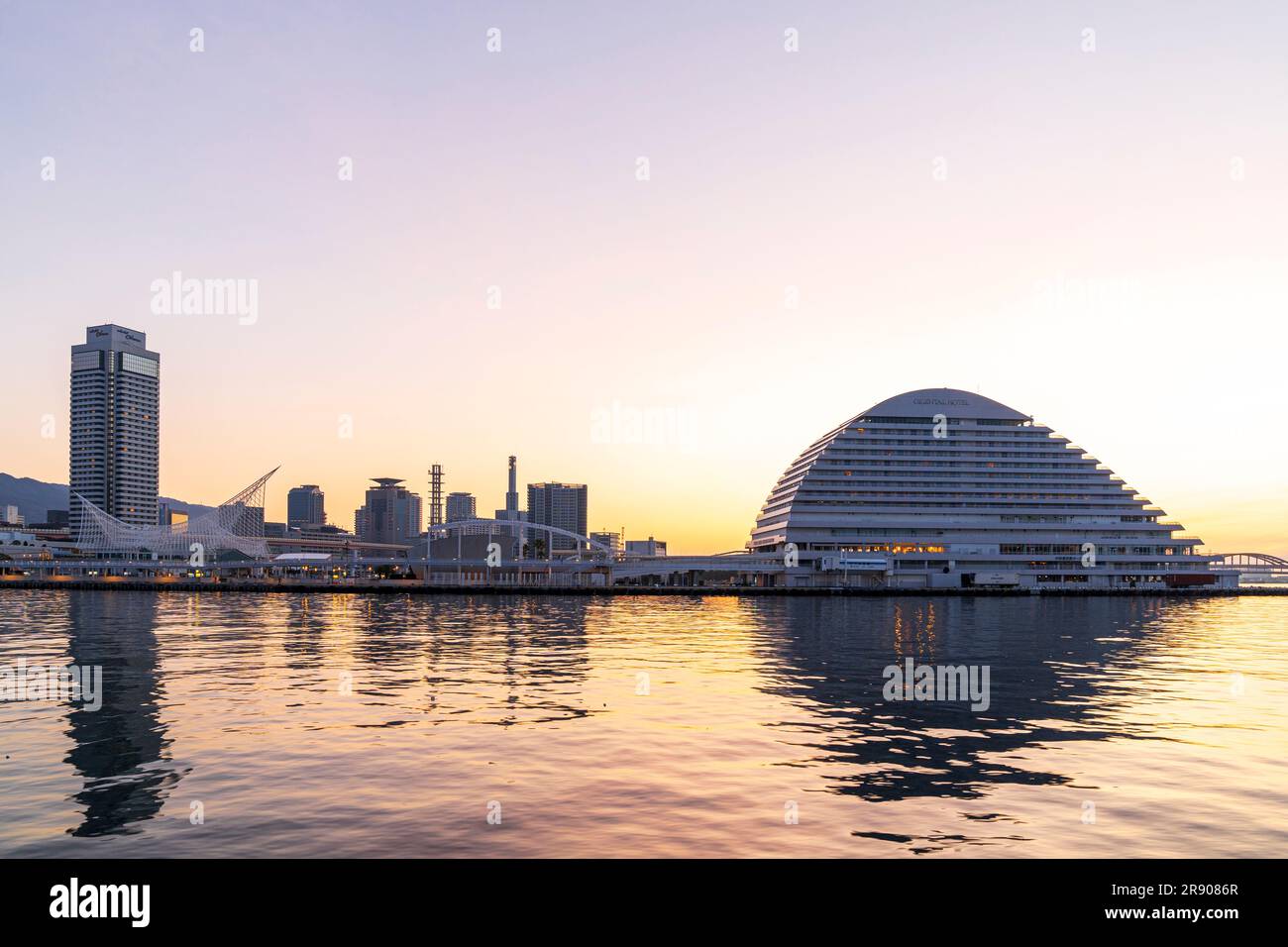 A clear dawn sky over the Kobe waterfront with the landmark Oriental