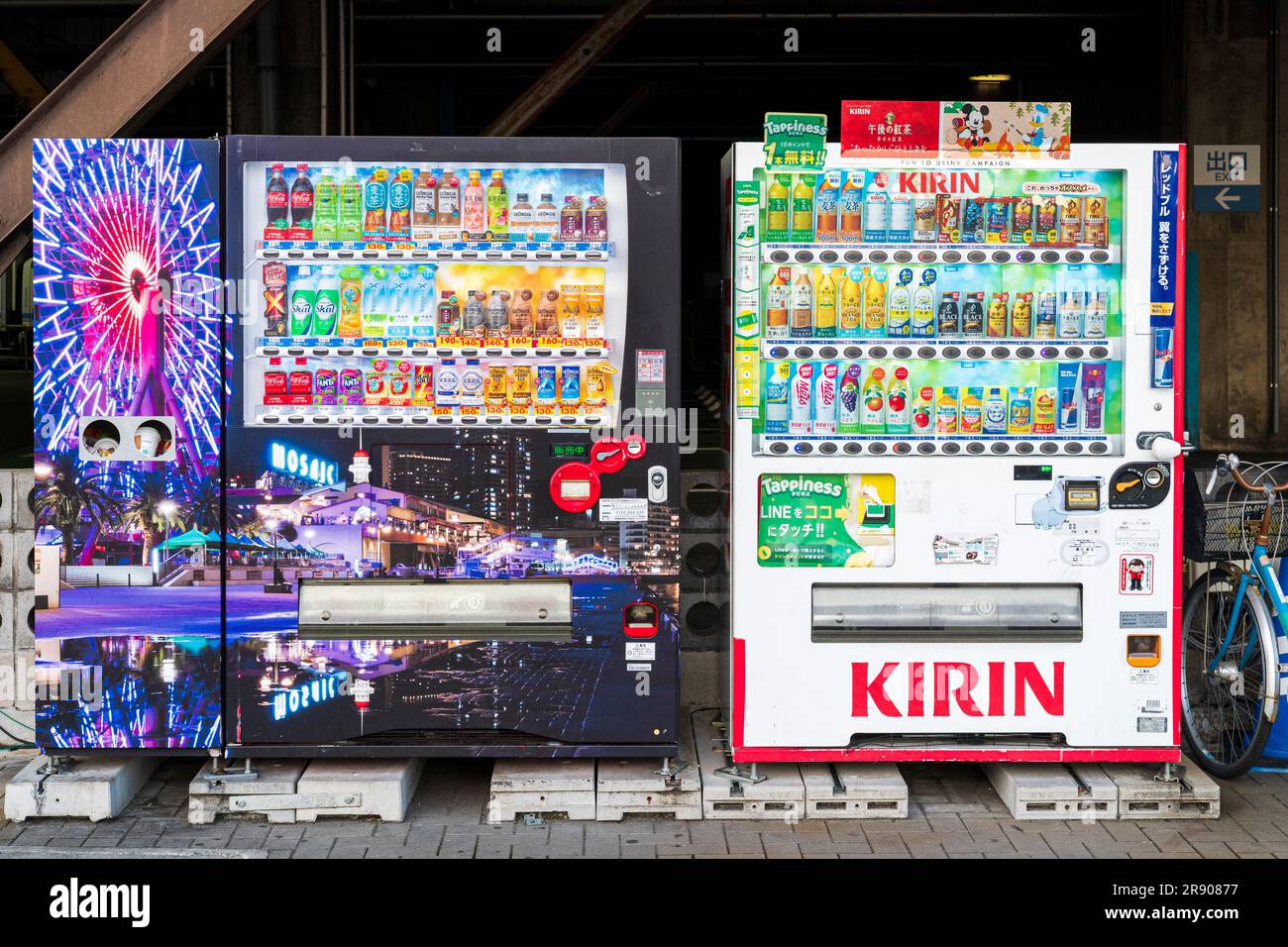 Two Japanese drink vending machines side by side. A Kirin drink company machine, the other a mosaic themed machine as part of Harborland area at Kobe. Stock Photo