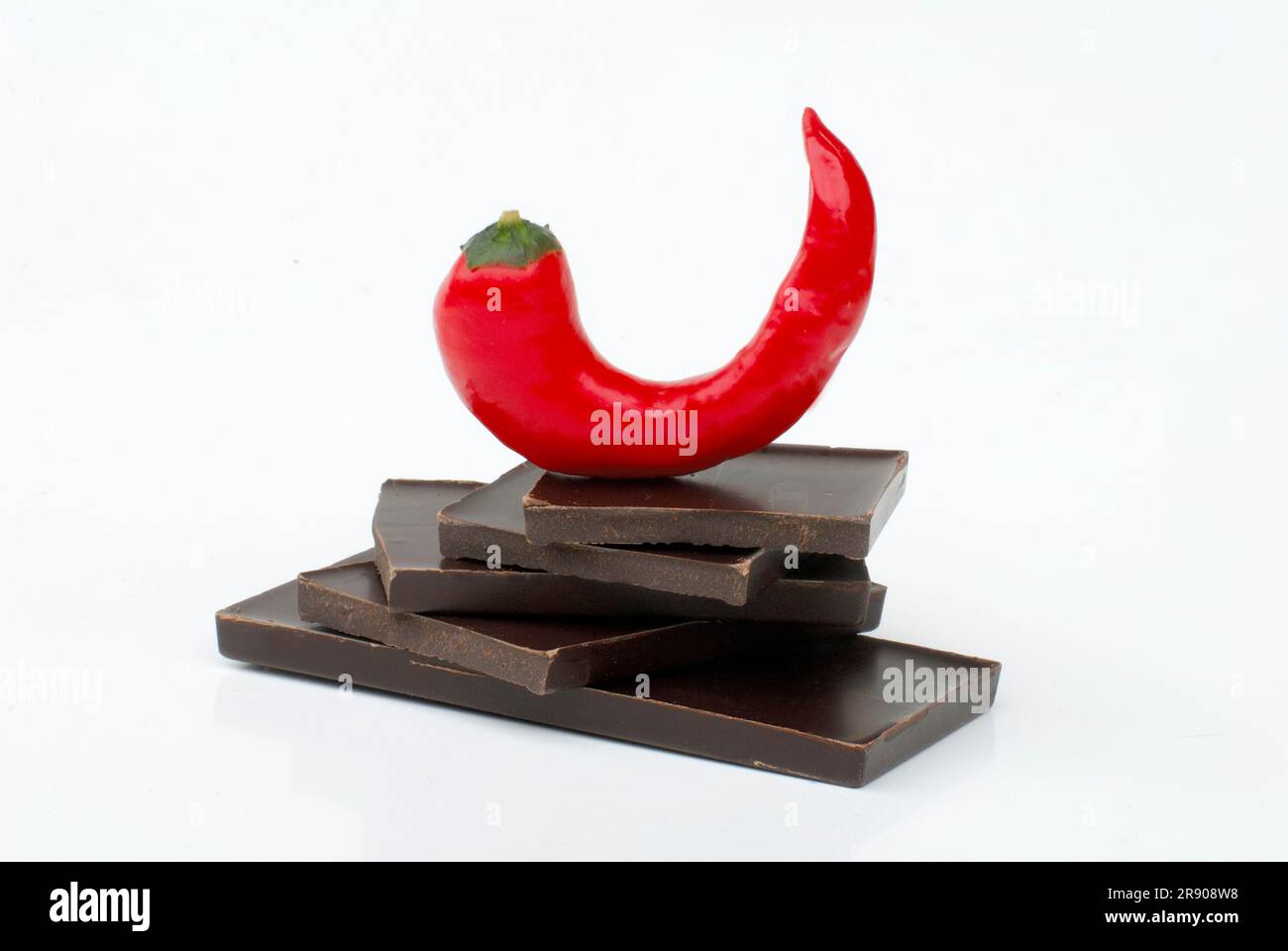 Chocolate pieces and chili pepper, piece, chocolate piece, dark, pepper, paprika, chili pepper, chili pepper Stock Photo