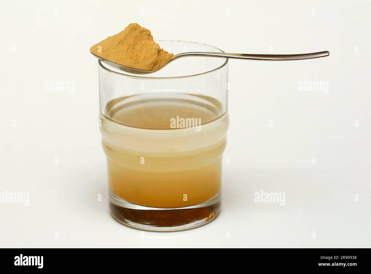 Red clay on spoon and glass with water, clay, healing earth, spoon ...