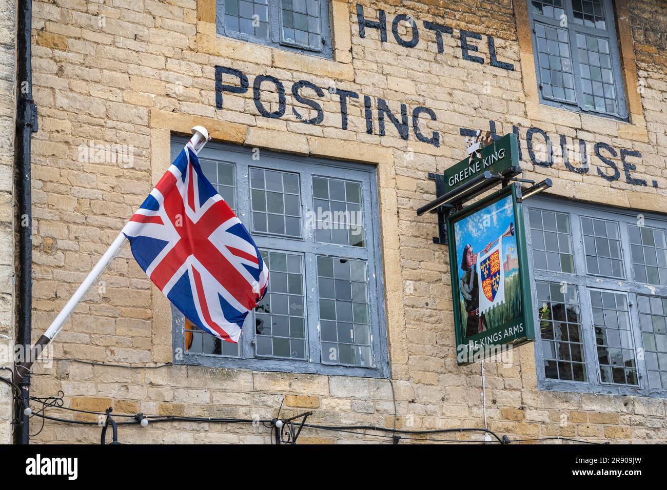 English flag and inn sign on the facade of the Hotel PostingHouse in