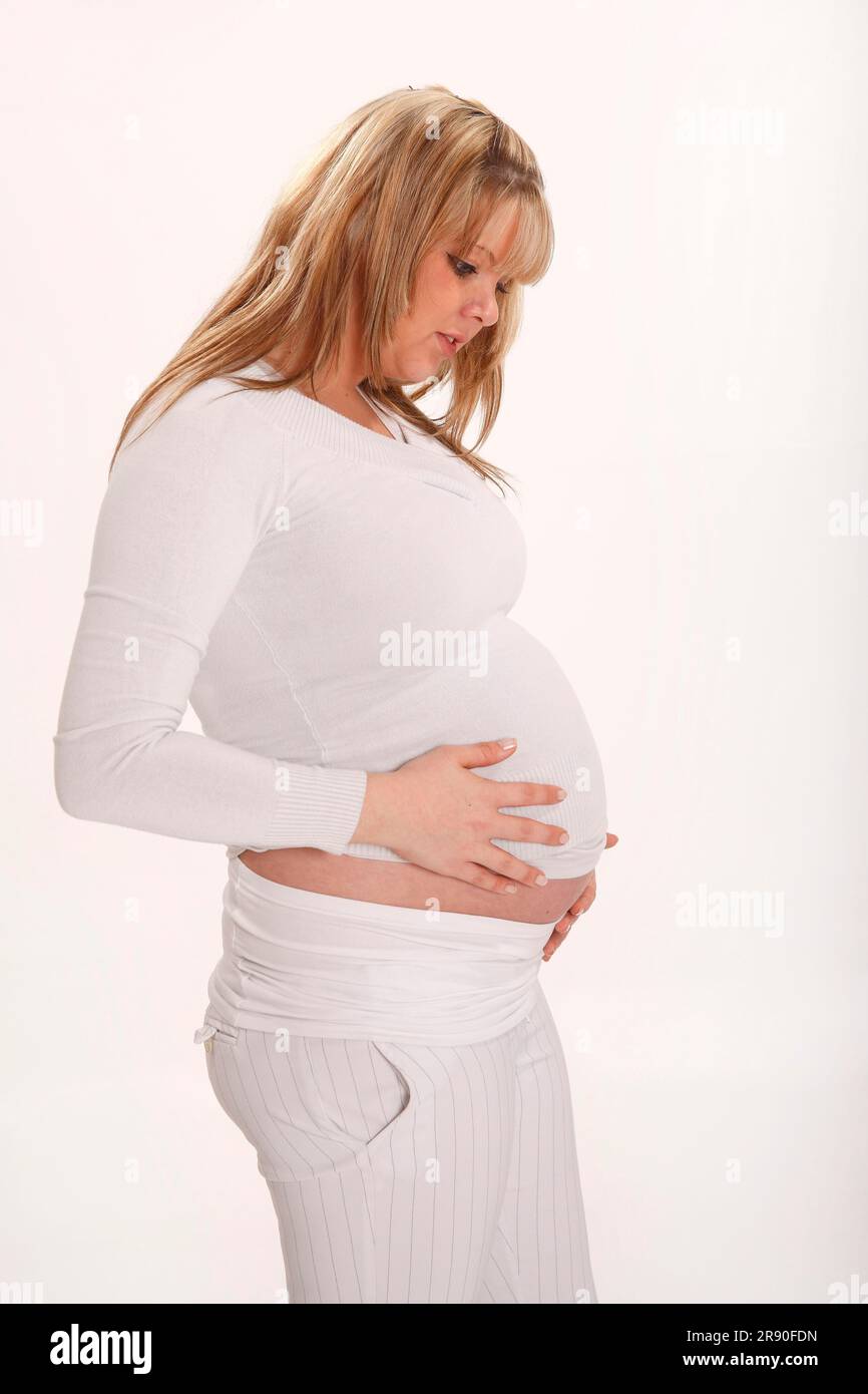 Pregnant woman holding her stomach Stock Photo