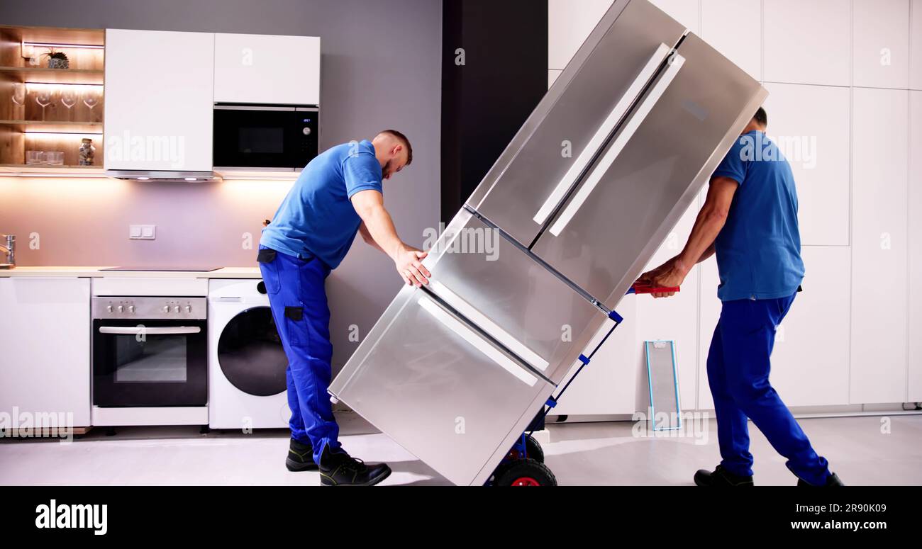 Delivery And Install Of Refrigerator Appliance. Mover Carrying Fridge