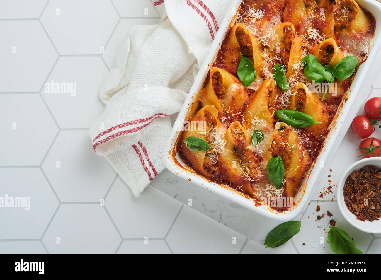 Cannelloni or conchiglioni. Baked stuffed pasta shells with bolognese