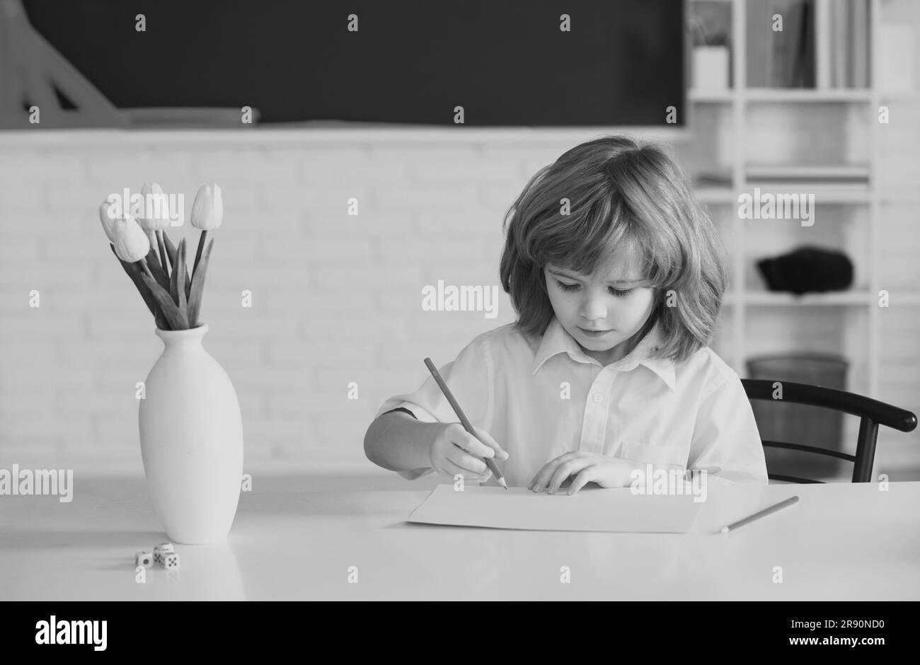 School boy with writing lesson. Kids in classroom at school Stock Photo