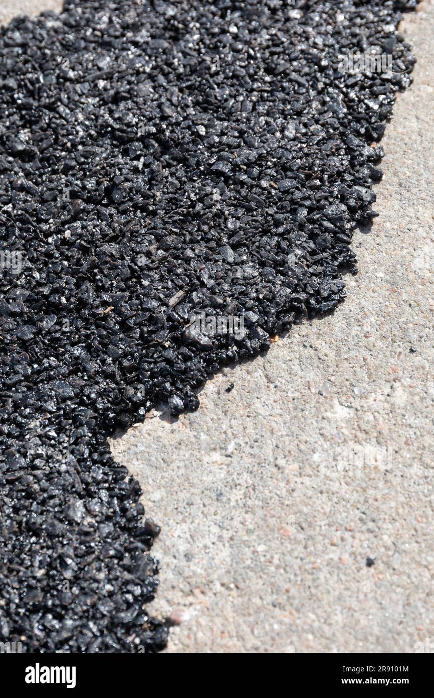 Asphalt filled in a crack in concrete Stock Photo Alamy