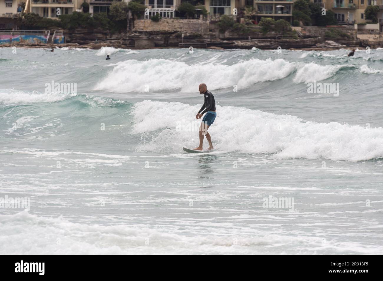 Surfer rides a wave at Bondi Beach, .also called Bondi Bay, is a famous