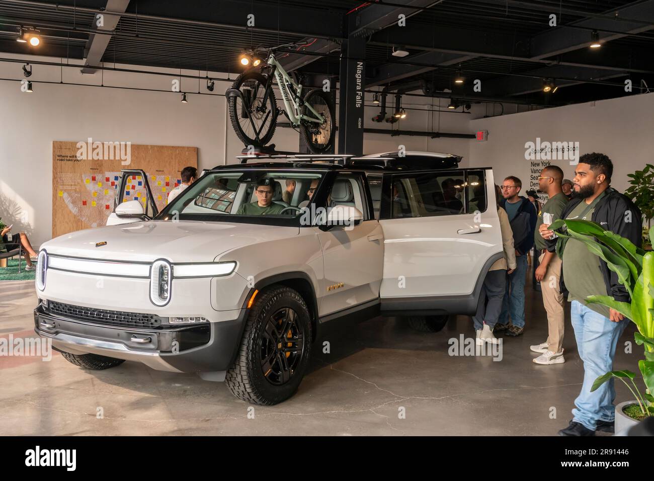 Grand Rivian Automobile enthusiasts attend the grand opening of a Rivian Spaces ...